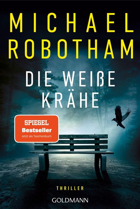 Oben steht "Michael Robotham", darunter "Die weiße Krähe", ein Thriller. Eine einsame Bank in nebligem Wald.