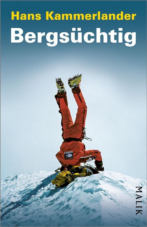 Oben steht "Hans Kammerlander", darunter "Bergsüchtig". Ein Kletterer im roten Anzug macht einen Handstand im Schnee.