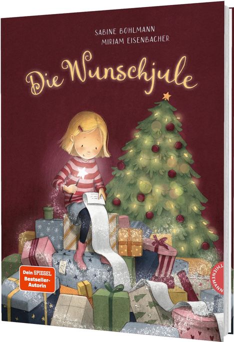 „Die Wunschjule“ von Sabine Bohlmann und Miriam Eisenbacher, Mädchen schreibt Wunschzettel vor Weihnachtsbaum.