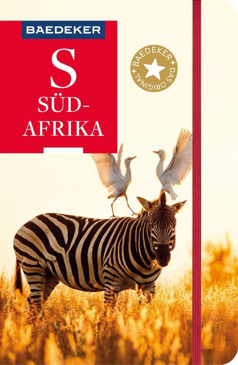 "BAEDEKER S SÜD-AFRIKA". Ein Zebra in einer goldenen Savannenlandschaft, zwei weiße Vögel landen auf seinem Rücken.