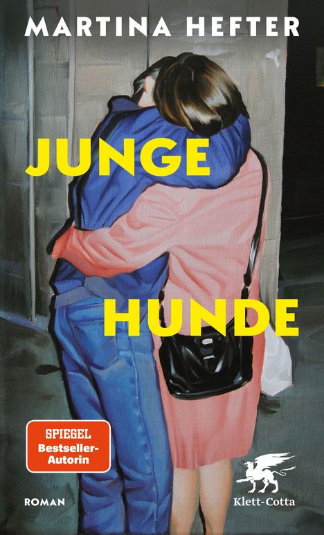 Oben: "MARTINA HEFTER". Mitte: "JUNGE HUNDE". Unten: "SPIEGEL Bestseller-Autorin". Illustration eines sich umarmenden Paares.