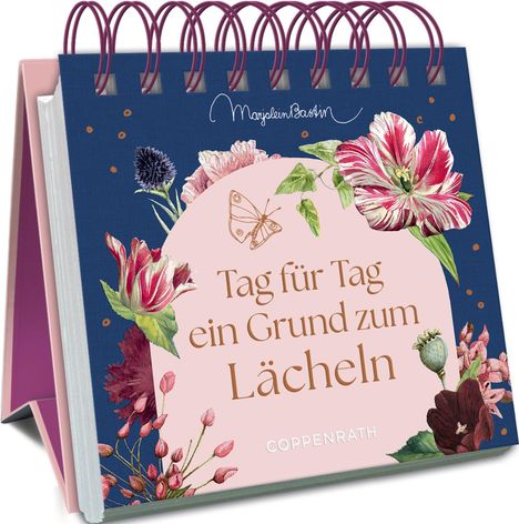 "Tag für Tag ein Grund zum Lächeln" in der Mitte. Illustration von Blumen, Schmetterling oben links, gebundene Spiralbindung.