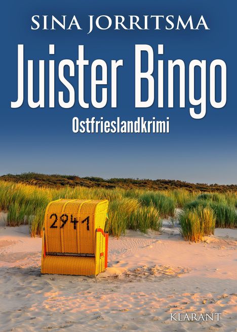 „Juister Bingo“, Ostfrieslandkrimi. Ein gelber Strandkorb mit der Nummer 2941 steht im Sand vor Dünen mit Gras.