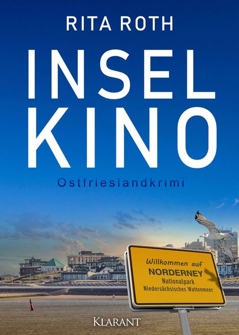 Text: "Rita Roth - Inselkino - Ostfrieslandkrimi". Gelbes Schild: "Willkommen auf Norderney". Küste, Möwe, Gebäude im Hintergrund.