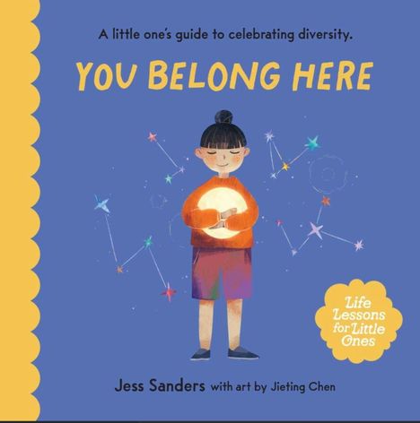 Text: "You Belong Here", "Life Lessons for Little Ones", "A little one's guide to celebrating diversity."

Illustration: Kind hält leuchtende Kugel, Sterne umrahmen es.