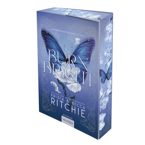 „Burn Bright“, blaue Flügel auf Blumenmotiv, Autoren: Krista & Becca Ritchie. Roman, Verlag Vajosh.