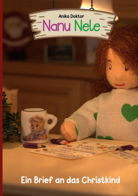 „Anika Doktor, Nanu Nele, Ein Brief an das Christkind“. Illustration: Puppe schreibt Brief, Teddy-Tasse neben ihr.