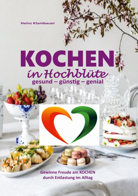 „KOCHEN in Hochblüte: gesund – günstig – genial“. Bunter Tisch mit Obst, Kuchen und Blütenzweig, zentrales Herz-Logo.