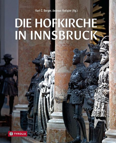 Titel: "DIE HOFKIRCHE IN INNSBRUCK". Statuen in Rüstungen stehen zwischen großen, beigen Marmorsäulen. Tyrolia Logo unten links.