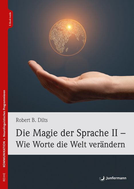 „Die Magie der Sprache II – Wie Worte die Welt verändern“ von Robert B. Dilts. Hand hält leuchtende Erde.