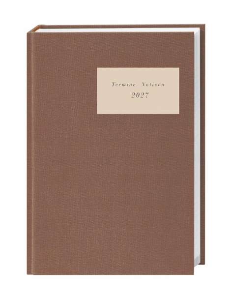 Brauner Kalender mit der Aufschrift "Termine Notizen 2027" auf einem cremefarbenen Etikett.