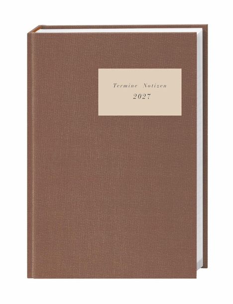 Ein braun gebundenes Notizbuch mit der Beschriftung "Termine Notizen 2027".