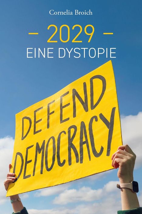 Oben steht "2029 - Eine Dystopie". Unten hält jemand ein gelbes Schild mit "DEFEND DEMOCRACY" vor blauem Himmel.