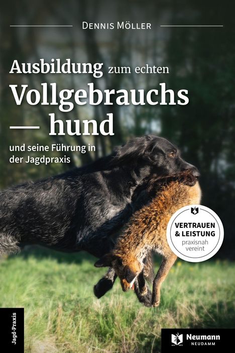Titel: "Ausbildung zum echten Vollgebrauchshund". Ein schwarzer Hund trägt ein Tier im Maul auf einer Wiese.
