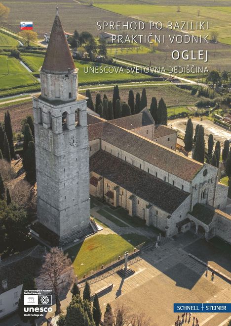 Text: "SPREHOD PO BAZILIKI PRAKTIČNI VODNIK OGLEJ UNESCOVA SVETOVNA DEDIŠČINA". 

Luftaufnahme einer Kirche mit Turm.