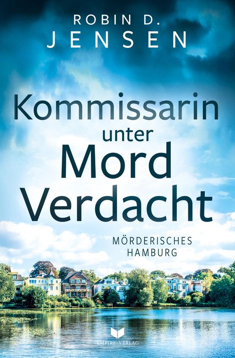 „Kommissarin unter Mordverdacht“ vor blauem Himmel. Unten Gebäude am Wasser. Logo: Buch mit geöffneten Seiten.