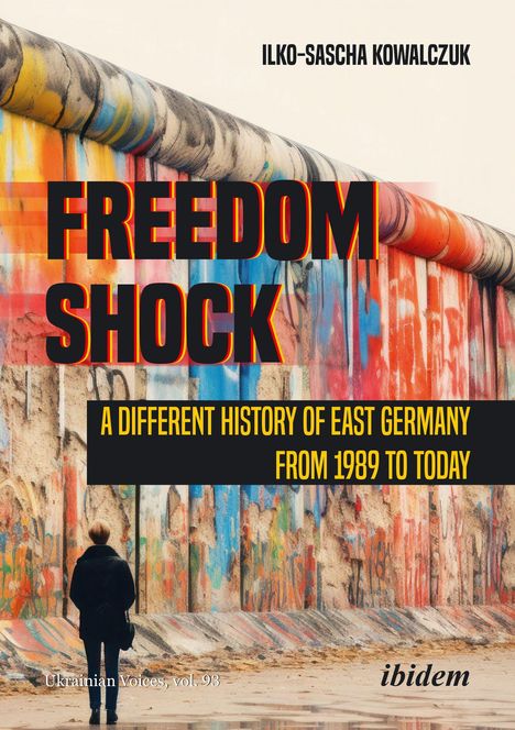 "FREEDOM SHOCK: A Different History of East Germany from 1989 to Today." Ein Gemälde einer bunten, bemalten Mauer.