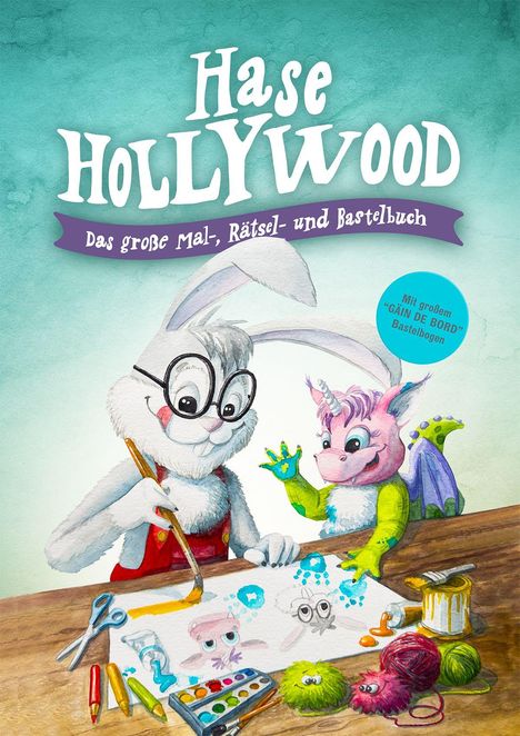 „Hase Hollywood“; „Das große Mal-, Rätsel- und Bastelbuch“. Ein Hase malt mit einem pinken, drachenartigen Wesen.