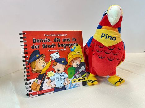 „Berufe, die uns in der Stadt begegnen“. Ein Kinderbuch mit fröhlichen Figuren und ein bunter Plüschpapagei namens Pino.