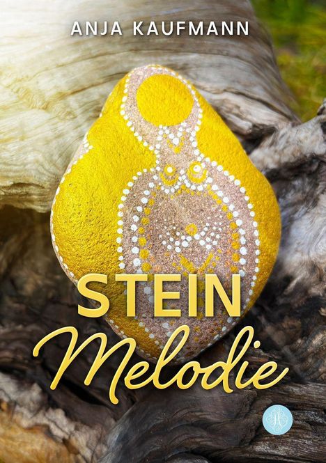 Text: "ANJA KAUFMANN", "STEIN Melodie". Gelber bemalter Stein auf verwittertem Holz.