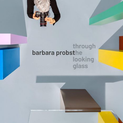 "barbara probst through the looking glass" in der Mitte. Frau mit Kamera von oben, umgeben von bunten, rechteckigen Formen.
