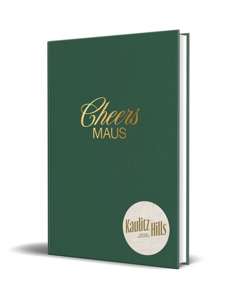 "Cheers MAUS" in Gold auf einem grünen Buchdeckel. Unten rechts ein rundes Logo mit "Kaulitz Hills" und "Sein aus Hollywood".