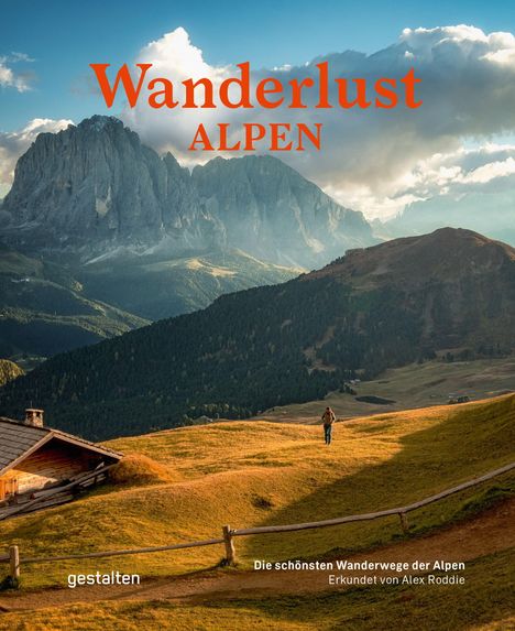 "Wanderlust Alpen" in roter Schrift. Im Hintergrund majestätische Berge, vorne ein Wanderer auf einer Wiese.