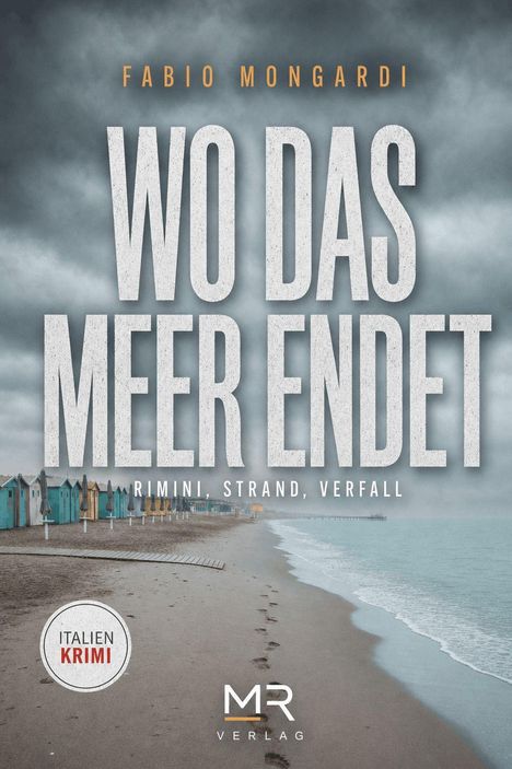 „WO DAS MEER ENDET“. Strand mit Fußspuren, Reihe bunter Strandhütten, trübes Wetter, Logo mit „MR Verlag“.