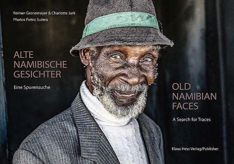 Text: ALTE NAMIBISCHE GESICHTER, OLD NAMIBIAN FACES. Ein älterer Mann mit Bart und Hut schaut freundlich in die Kamera.