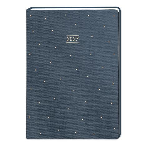 Text: "2027". Dunkelblaue Oberfläche mit kleinen, verstreuten Punkten.