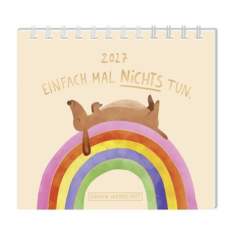 Text: "2027 Einfach mal nichts tun. GRAFIK WERKSTATT". Illustration: Hund liegt entspannt auf einem bunten Regenbogen.