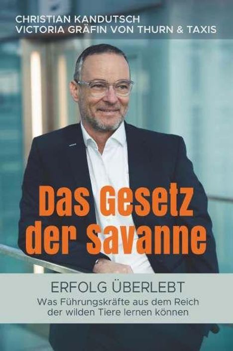 "Das Gesetz der Savanne. Erfolg überlebt: Was Führungskräfte aus dem Reich der wilden Tiere lernen können." Mann im Anzug.