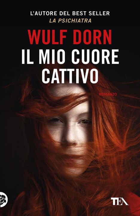 "Wulf Dorn, Il Mio Cuore Cattivo." Rotes Haar weht um ein ernstes Gesicht, teilweise verdeckend.