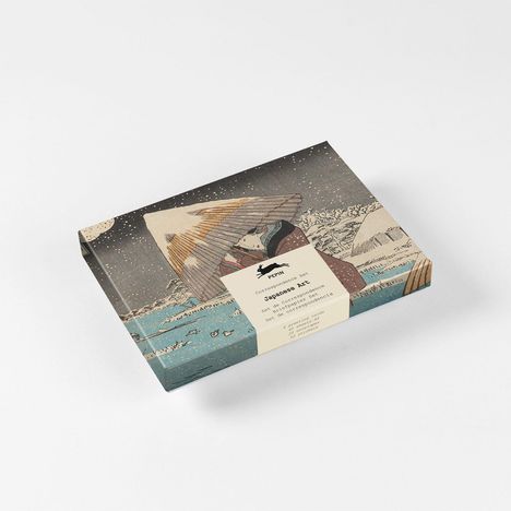 "Japanese Art" steht auf einer Verpackung mit traditioneller japanischer Kunst. Eine Figur im Schnee, Regenschirm haltend.