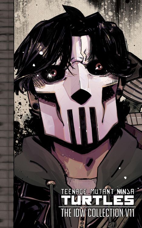 "Teenage Mutant Ninja Turtles: The IDW Collection V11." Illustration eines maskierten Charakters mit schwarzem Haar.