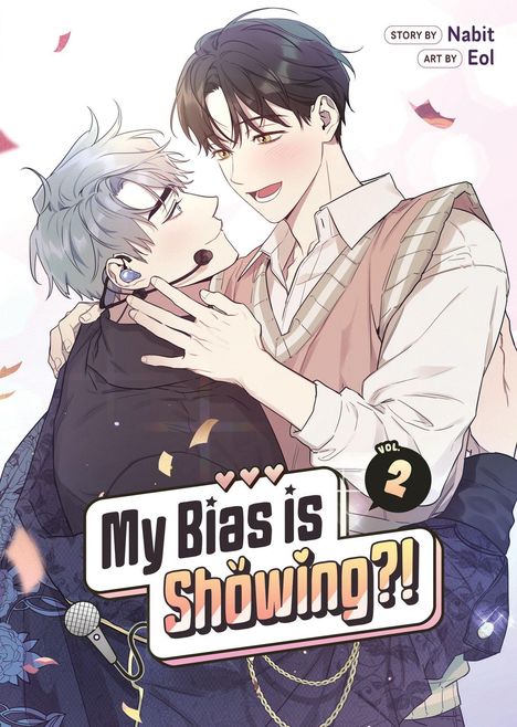 "My Bias is Showing?! Vol. 2, Story by Nabit, Art by Eol." Zwei lächelnde Figuren, eine mit Headset, halten sich zärtlich.