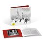 Der Text auf der Hülle lautet: „Winter Tales, The Britten Christmas Album, RIAS Kammerchor Berlin, Justin Doyle“. Im Hintergrund sind Personen im Schnee vor einem Denkmal zu sehen. Ein aufgeklapptes Booklet liegt davor.