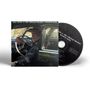 "Neil Young & The CHROME HEARTS - SECOND SONG." Ein Mann sitzt am Steuer in einem Auto, daneben eine CD.