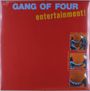 „GANG OF FOUR“ steht oben in Blau, „entertainment!“ darunter in Gelb. Illustration: Zwei Comic-Stil-Panels mit Händedruck.