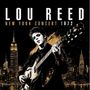 "Lou Reed New York Concert 1972" steht über einem Gitarristen vor einer Skyline, schwarz-goldfarbenes Design.