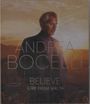 Text: "ANDREA BOCELLI BELIEVE LIVE FROM MALTA." Ein Mann im Anzug vor einem Sonnenuntergang in einer Landschaft.