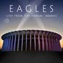 "EAGLES LIVE FROM THE FORUM MMXVIII" über einem beleuchteten runden Gebäude bei Abenddämmerung.