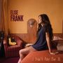 „Elise Frank“ oben links, „I Didn't Pay For It“ unten rechts. Eine Frau sitzt auf einem Bett, im Hintergrund eine Gitarre.