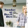 "Sunday at Devil Dirt, Isobel Campbell & Mark Lanegan." Zwei Personen auf einer Veranda, Frau rechts, Mann links.