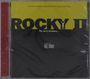 CD-Hülle mit gelbem und schwarzem Cover. Text: "ROCKY II", "The story continues...", Musik von Bill Conti.