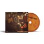 CD-Cover und Disc mit Text: "RAY WYLIE HUBBARD", "REEL 2 REEL 4 REAL". Person sitzt neben Musikinstrumenten.