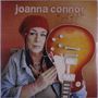 „joanna connor Best of Me“ steht oben. Eine Frau mit roter Mütze hält eine elektrische Gitarre.