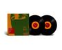 Roter Textblock: "Power Corruption". Zwei Schallplatten mit orange-rotem Zentrum und ein grünes Cover mit Augenmotiv.