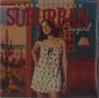 Texte: "AMBER LAWRENCE", "SUBURBAN Cowgirl". Frau im Sommerkleid, Western-Hintergrund mit Kakteen und Pferden.