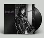Text: "Joan Jett, Bad Reputation". Schwarz-weißes Cover mit Person in Lederjacke und Schal, Vinyl-Schallplatte sichtbar.